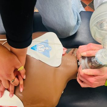 e-ILS e-PILS training practical session showing CPR compressions, AED use, and airway management on a manikin